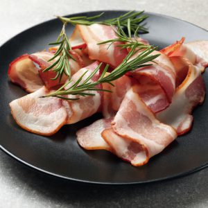 Bacon on plate served with rosemary